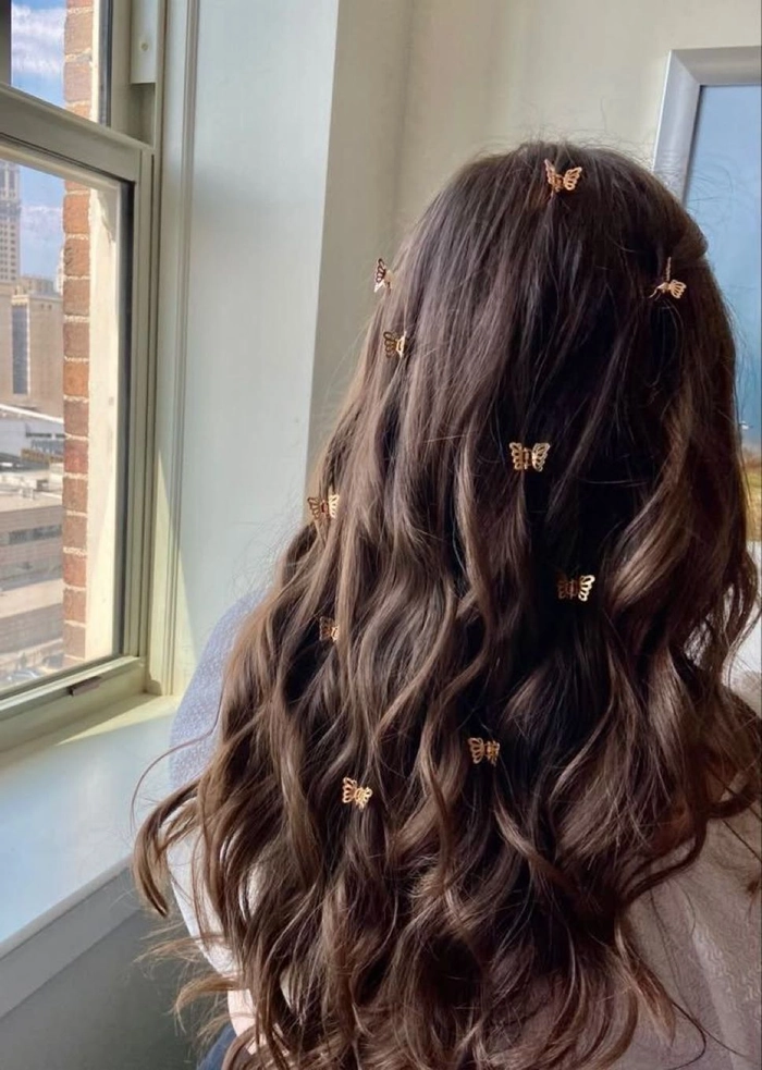 Bright butterfly clips in a festival updo hairstyle Festival hairstyle with colorful butterfly clips adorning a braided updo