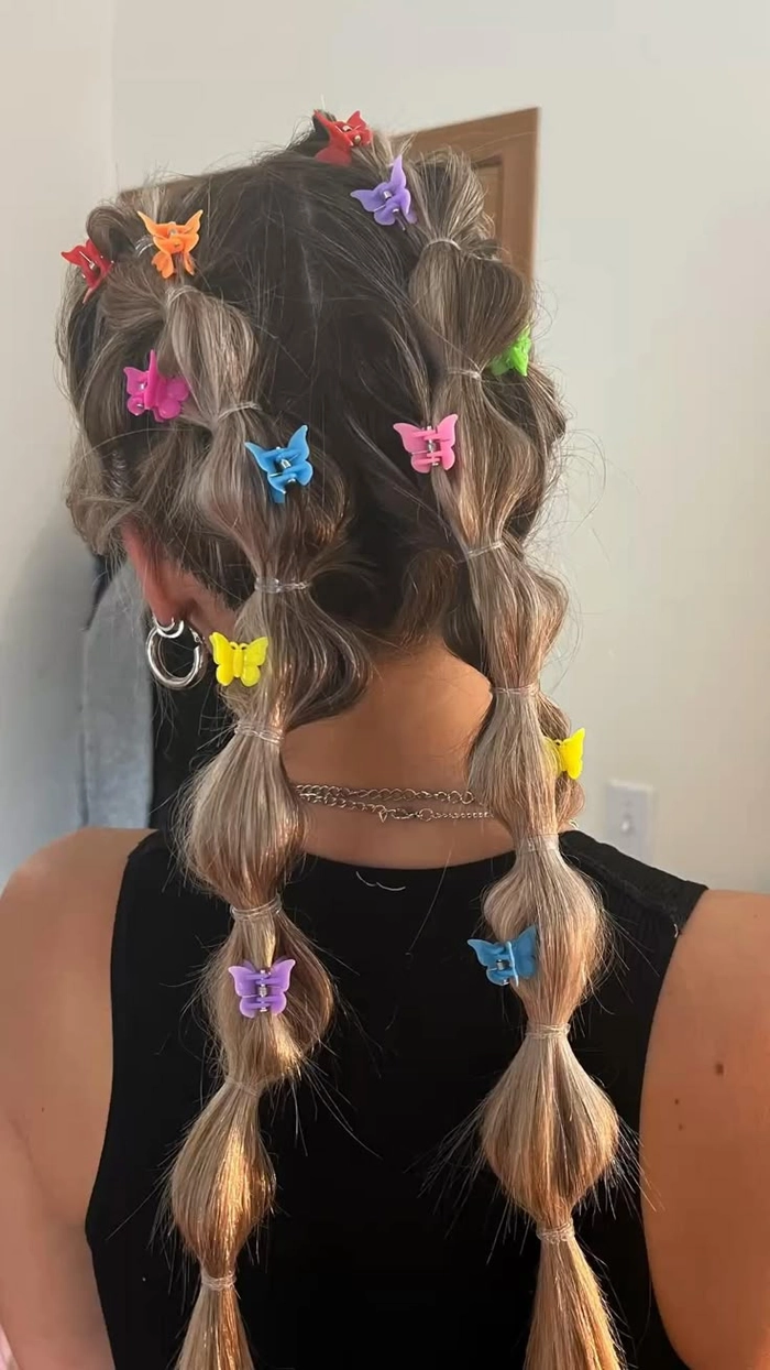Curly hair festival hairstyle with floral accents and loose curls