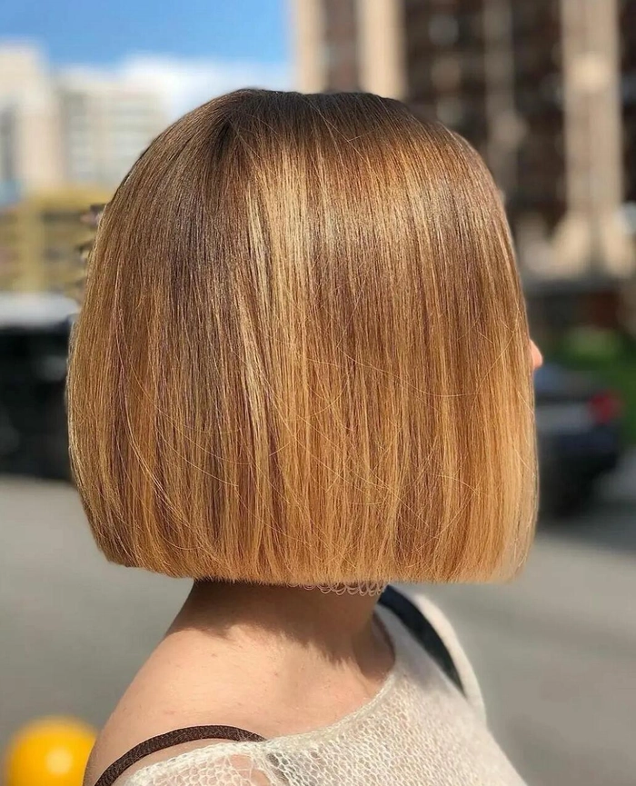 Festival hairstyles for bob cuts featuring a braided crown with glitter and flower accents