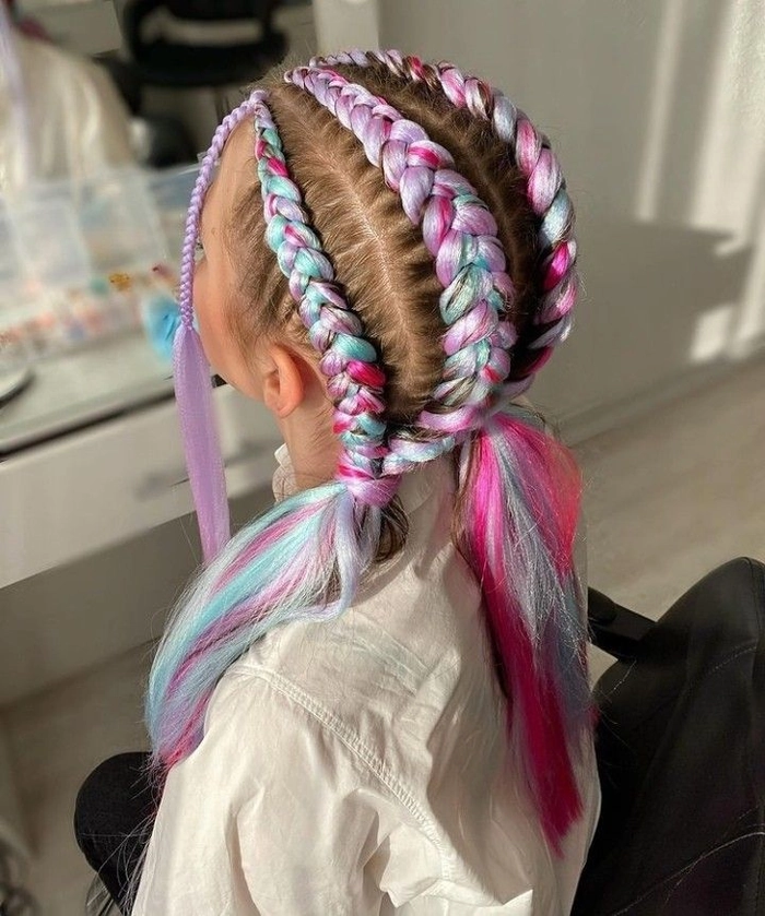 Child with a festive braided hairstyle and glittery hair accessories