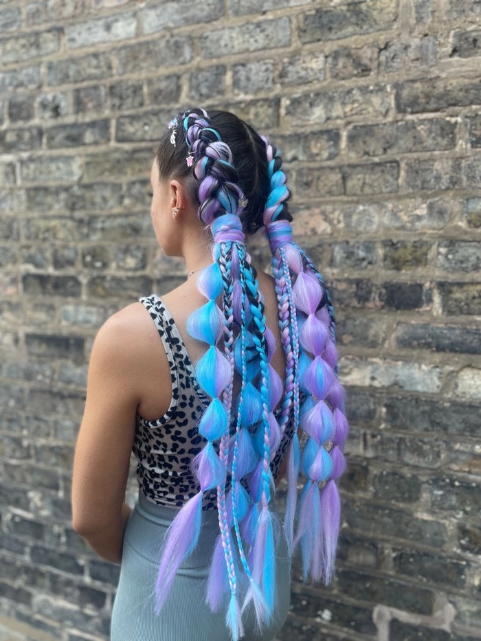 Festival Hairstyles for Men - Braided Look with Floral Accents Man with a trendy braided festival hairstyle and floral accessories