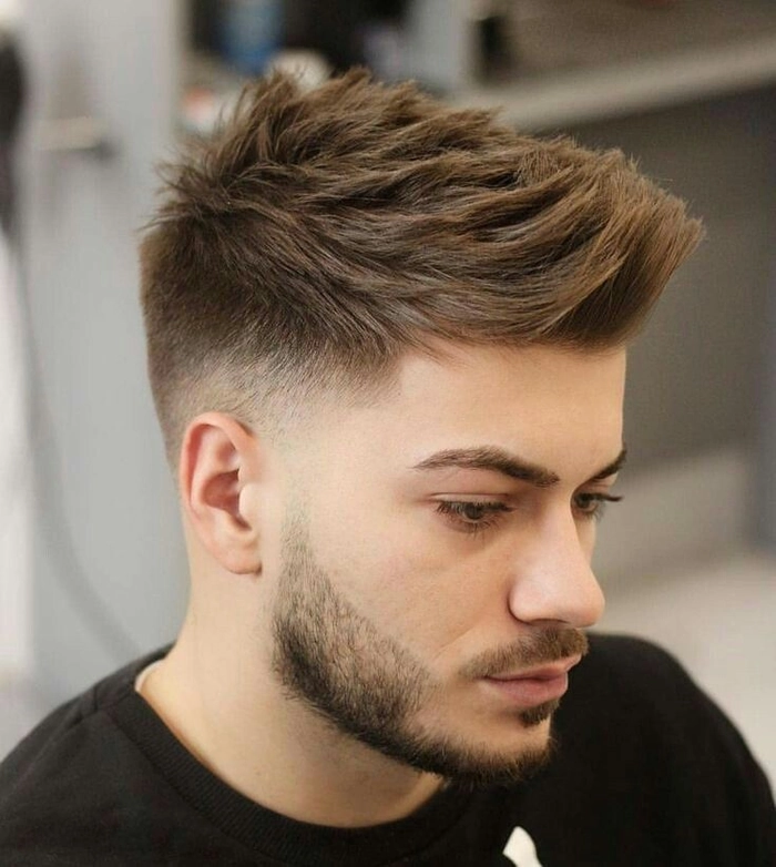 Trendy braided festival hairstyle for men Man with braided festival hairstyle under colorful lights
