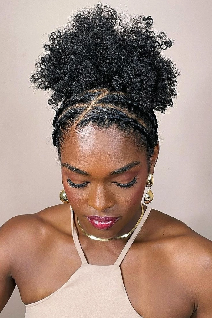 Festival hairstyle inspiration featuring bold braids and metallic accents for natural black hair Vibrant festival braids with gold accessories on natural black hair