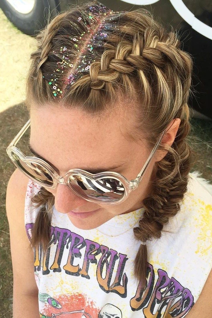 Easy festival hairstyle for thin hair featuring braids and floral accents Festival hairstyle for thin hair with braids and small floral clips