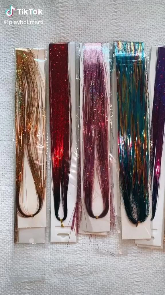 Festival hairstyle with shimmering hair tinsel woven through braided locks
