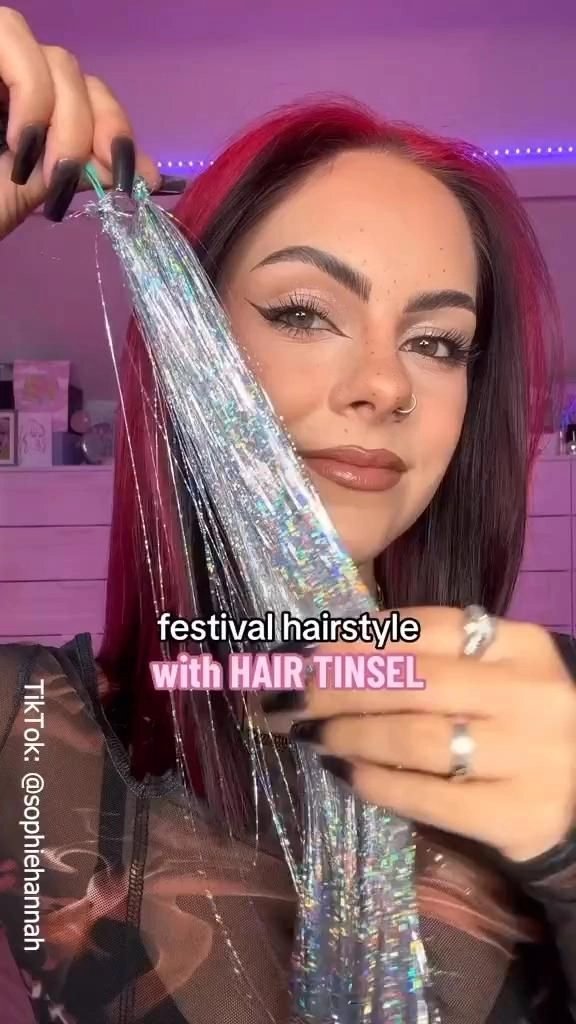 Festival hairstyle with shimmering hair tinsel woven through braids