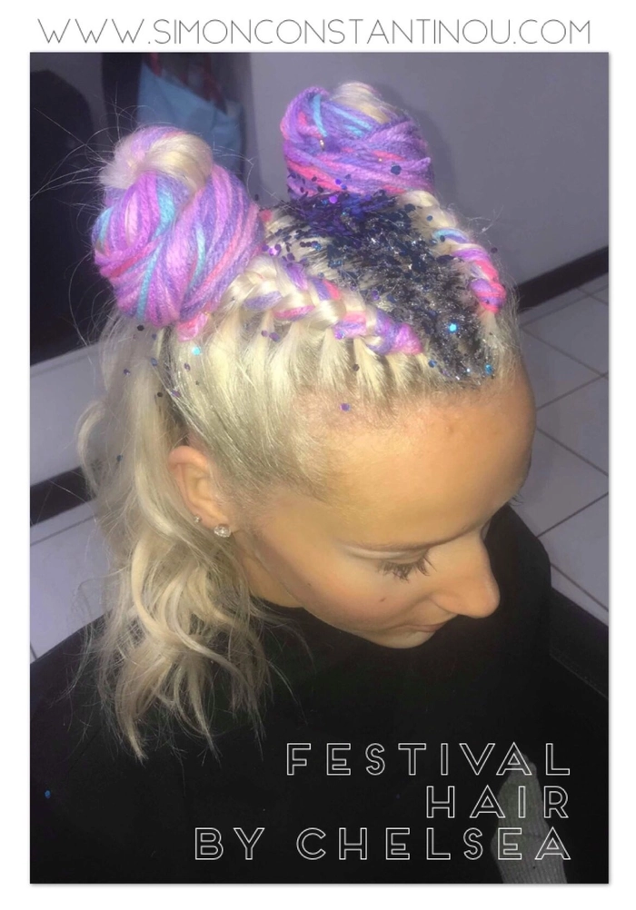 Little girl with braided festival hairstyle and colorful flowers