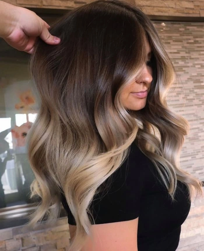 Festival hairstyle 10 featuring ombre color with twisted braids and floral accents Festival ombre hair style with braided crown and loose waves for music events