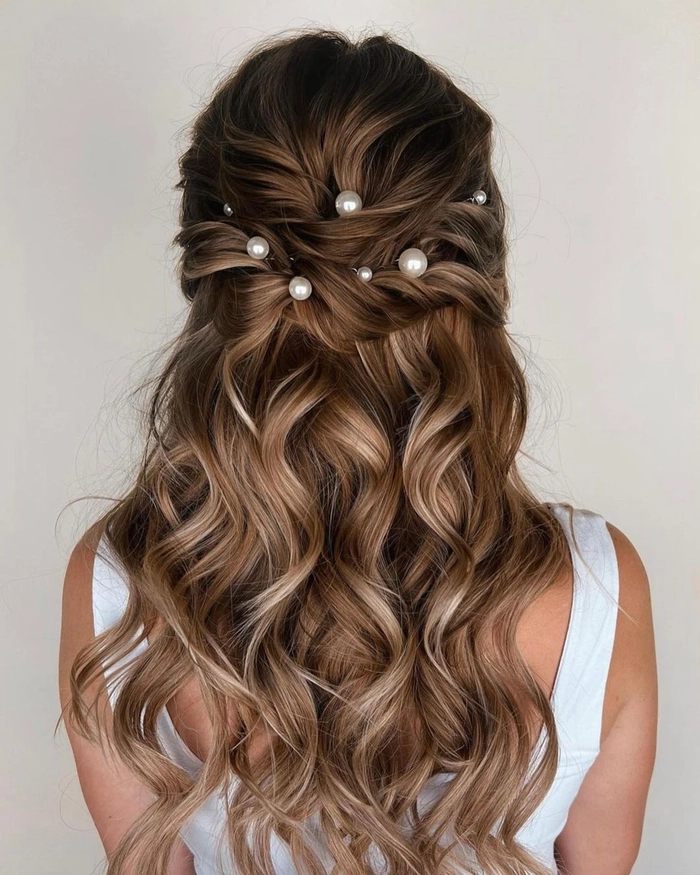 Pearl-adorned festival hair inspiration for summer events Festival hairstyle with pearls elegantly woven into braids