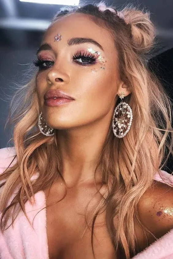 Festival hairstyle with temporary color for a fun summer music event Woman with a colorful braided festival updo featuring temporary pink and blue highlights
