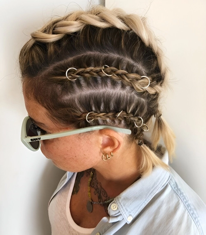 Festival hairstyle for thin hair featuring a crown braid with delicate floral details A stylish festival updo for thin hair with braided accents and small flowers