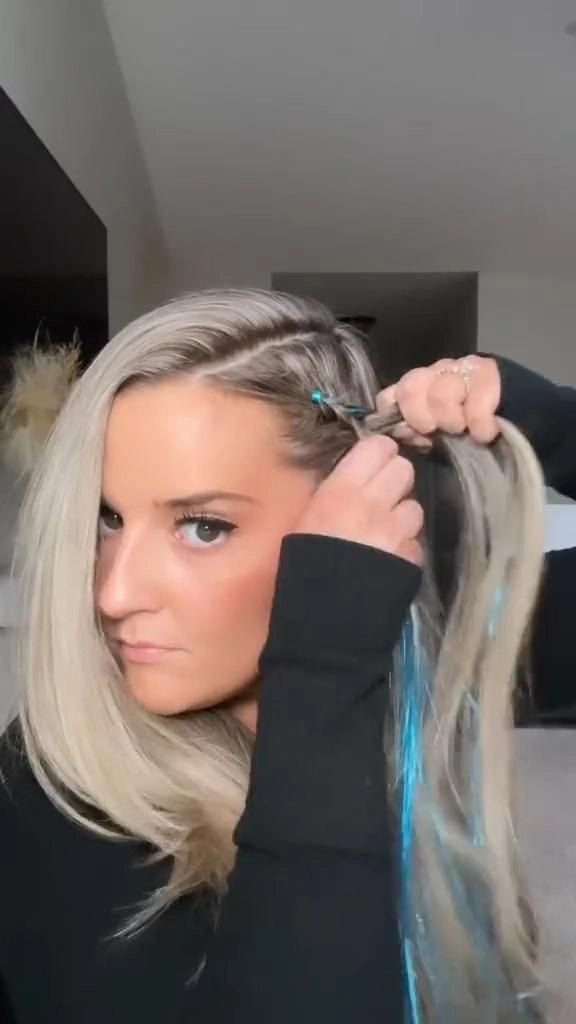 A woman with braided festival hairstyle decorated with gold hair tinsel