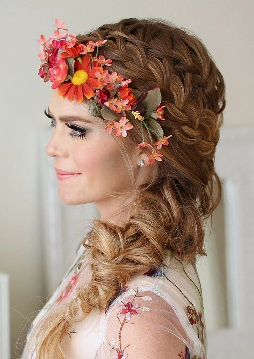 Bohemian festival hairstyle with vibrant flowers woven through braids