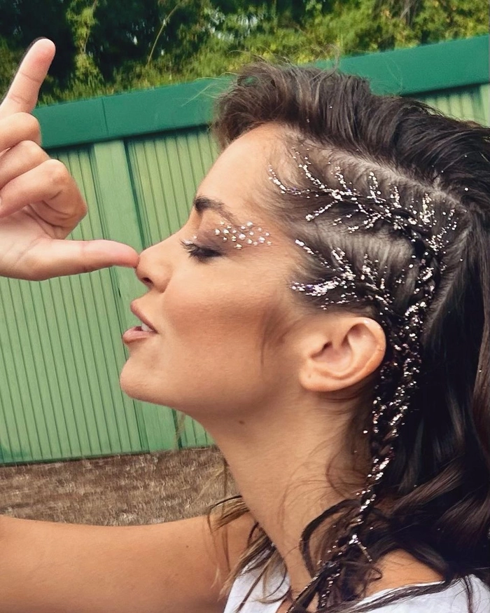 Festival hairstyle with multicolored glitter and braids