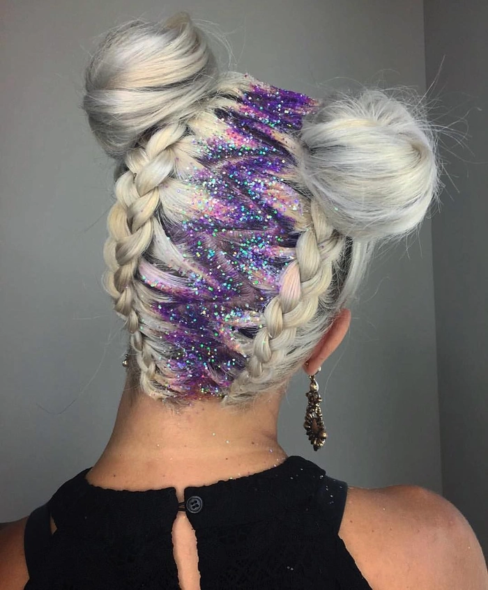 Woman with glitter-infused braided updo at outdoor music festival