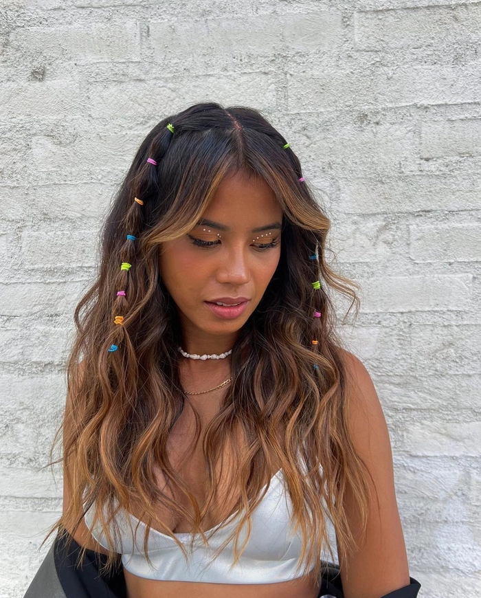 Woman with a braided updo wrapped in a patterned scarf for a festival look