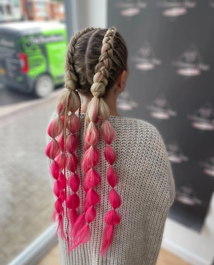 Braided updo with red scarf wrapped around the crown for a vibrant festival look