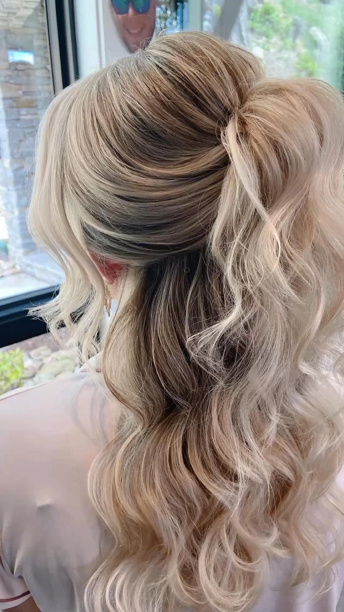 Festival half up half down hairstyle with braided accents and floral accessories
