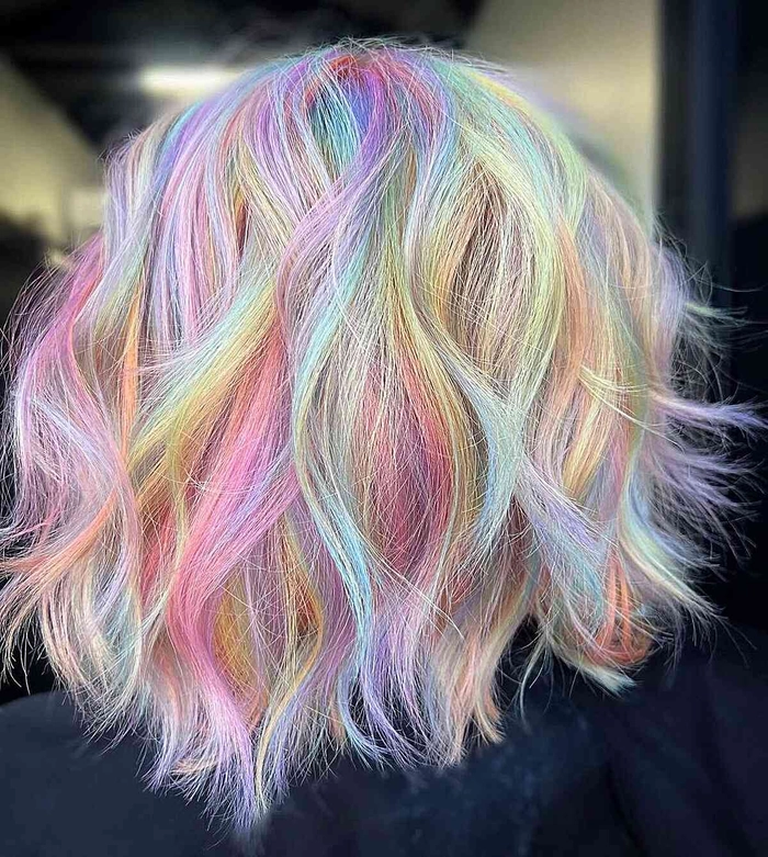 Creative pastel hair braid style for a vibrant music festival look Festival hairstyle with pastel pink and blue braids decorated with flowers