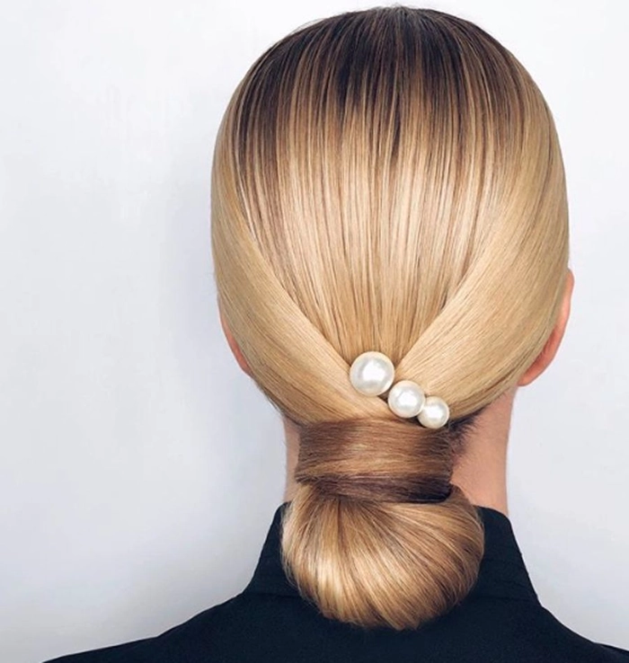 Festival Hairstyle 10 - Pearl Accented Braided Updo Festival hairstyle with pearls woven through braids and loose waves
