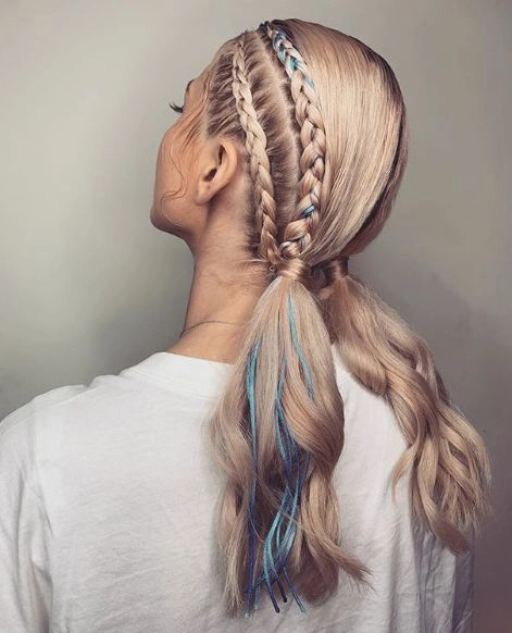 Festival ponytail hairstyle with braided detail and floral accessories