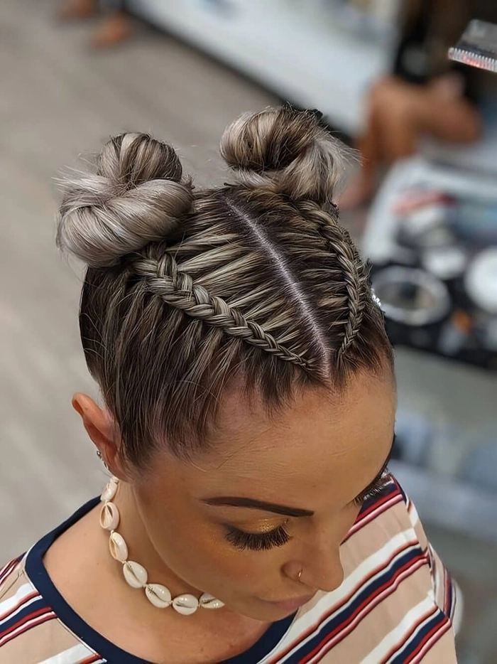 Festival hairstyle with space buns and colorful accessories