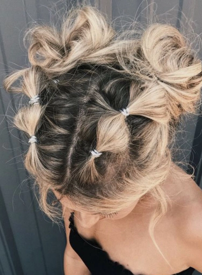 Elegant festival updo hairstyle with braided crown and floral accents