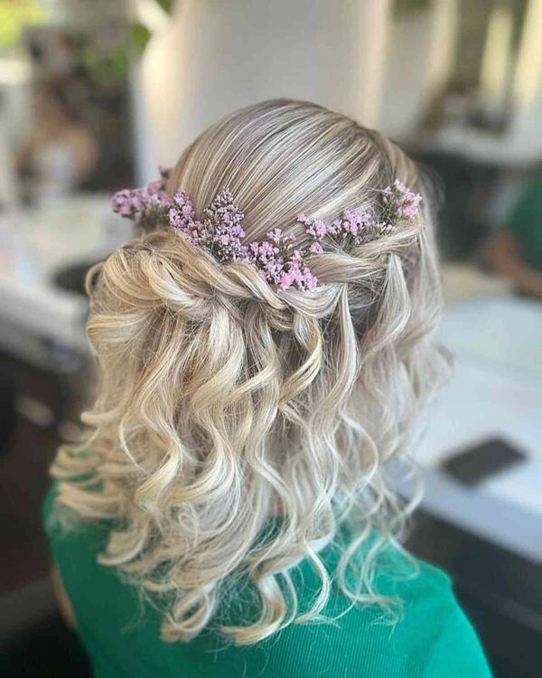 A stylish festival updo hairstyle with braids and flowers