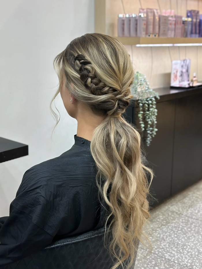 Festival updo hairstyle featuring twisted braids and floral accents