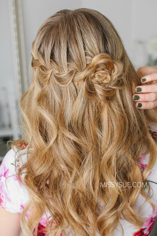 Boho waterfall braid with floral accents for music festivals Festival waterfall braid hairstyle with flowers and loose waves