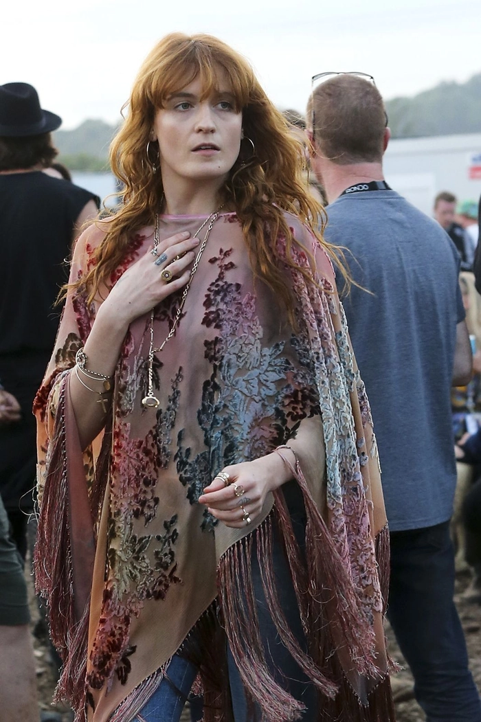 Glastonbury hairstyles featuring a messy bun with glitter roots for festival season
