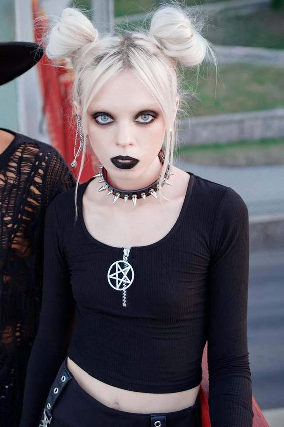 Dark braided updo with silver skull pins for gothic festival hair