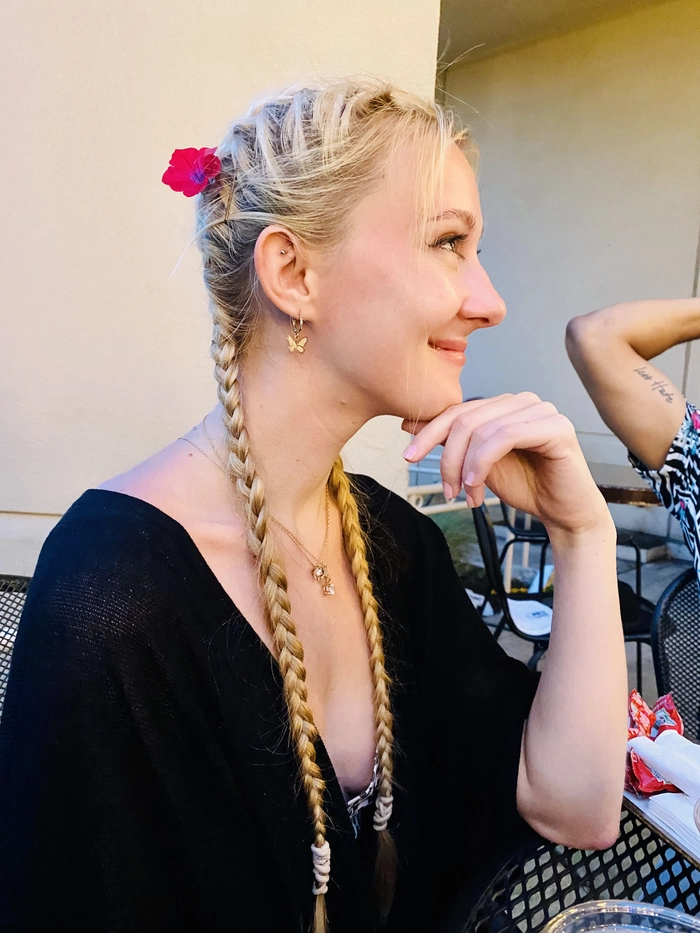 Line 1: Festival braided hairstyle with colorful beads woven into a crown braid