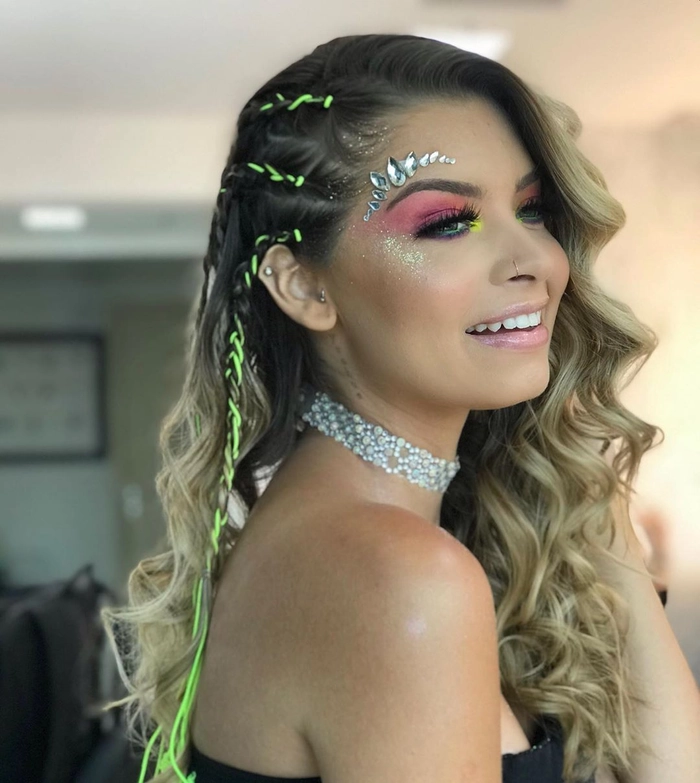 Stylish festival hairstyle with braids and flowers for electronic music events Creative braided updo with floral accents for a Tomorrowland festival look