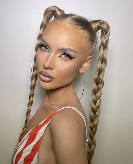 Lollapalooza festival hairstyle featuring braided updo with vibrant extensions Edgy Lollapalooza hairstyle with braids and colorful hair accessories