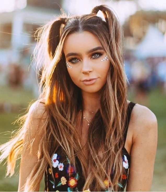 Lollapalooza festival hairstyle inspiration featuring a braided updo with colorful accents Festival-ready braided updo with vibrant hair accessories for Lollapalooza