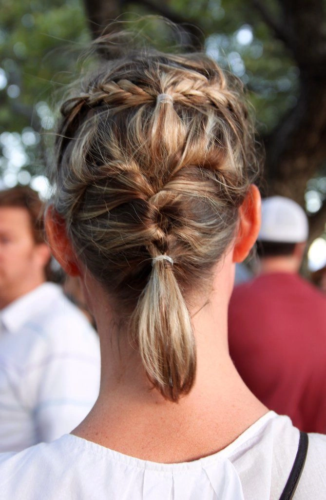 Lollapalooza hairstyle inspiration with braids and floral accents Festival-ready braided updo with flowers for Lollapalooza
