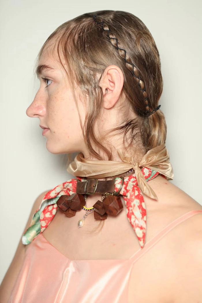 Bold and intricate maximalist festival hairstyle with vibrant accessories and braids