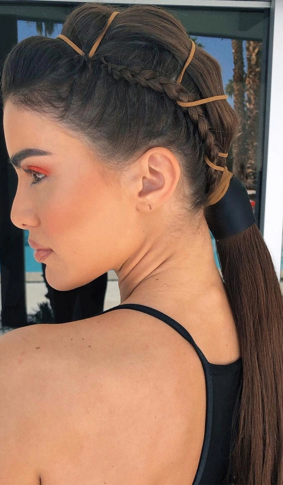 Festival hairstyle inspiration: a messy, textured updo perfect for dancing all day A messy festival hairstyle with loose braids and flyaway strands for an effortless bohemian look