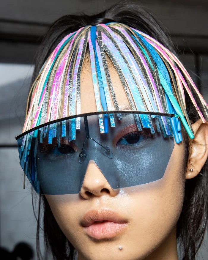 Festival hairstyle for night time with glitter accents and braided details