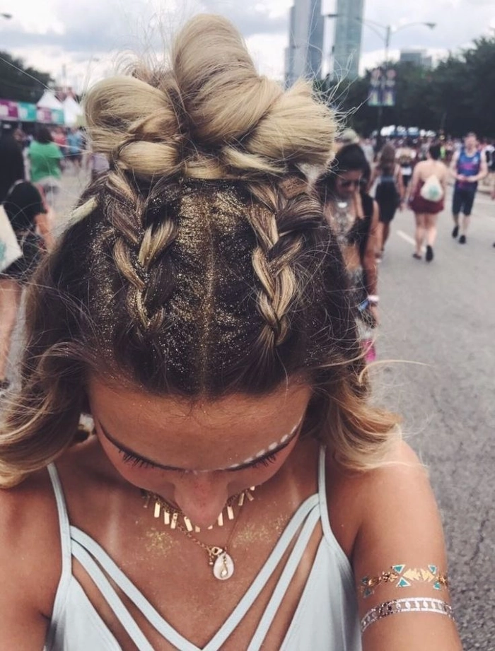 Woman with glittery braided updo for a night time festival hairstyle