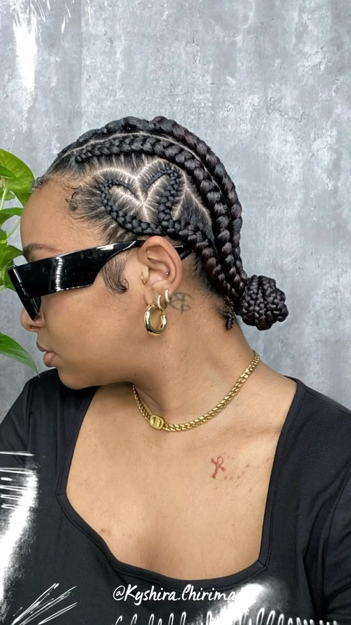Protective festival hairstyles braided updo with colorful beads and floral accents Model wearing a protective braided festival hairstyle with decorative beads and flowers