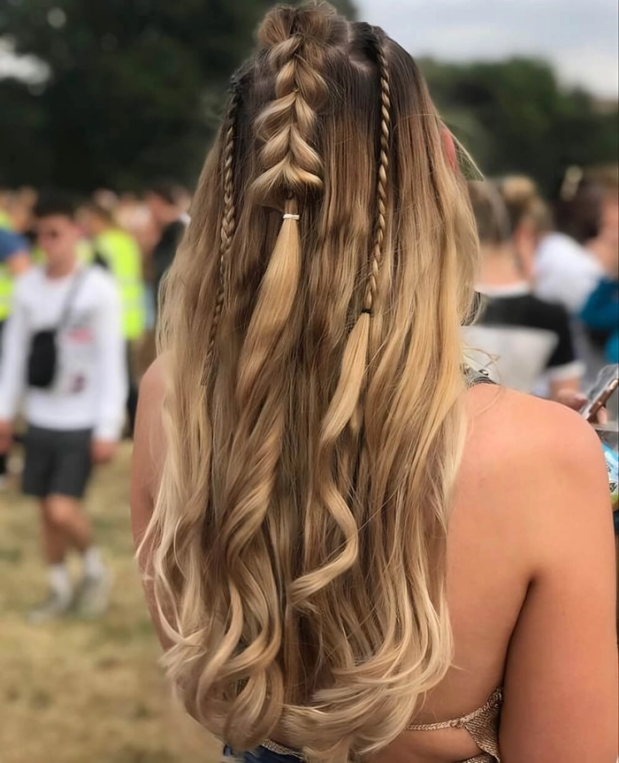 Soft braids and floral accents for a romantic festival hairstyle