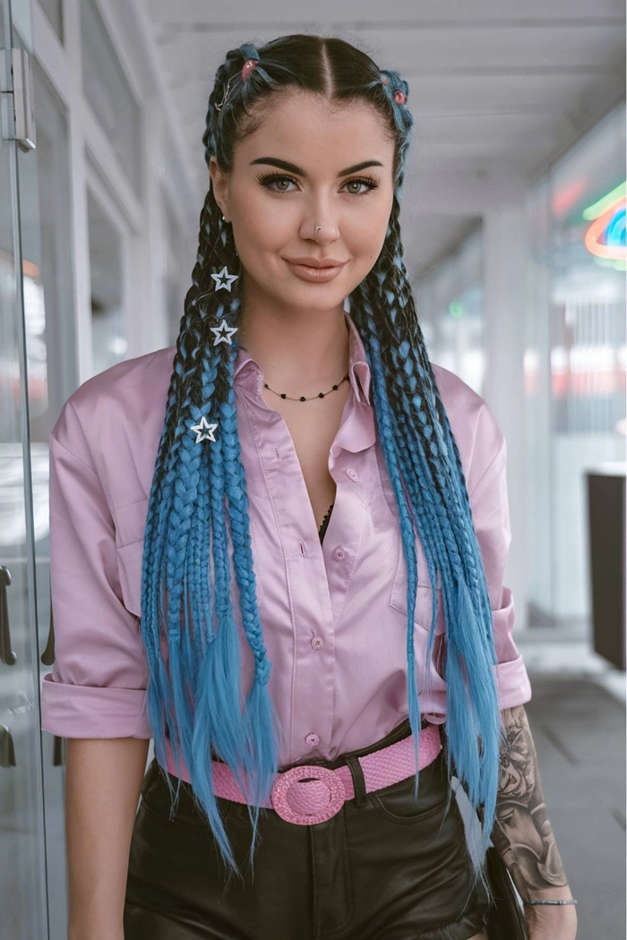 Whimsical festival hairstyle with braided crown and floral decorations