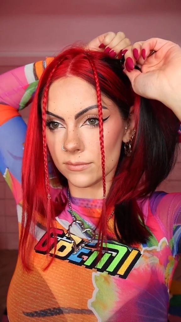 Get inspired by Y2K festival hairstyles like these playful space buns with neon highlights Brightly colored Y2K festival hairstyles with butterfly clips and space buns