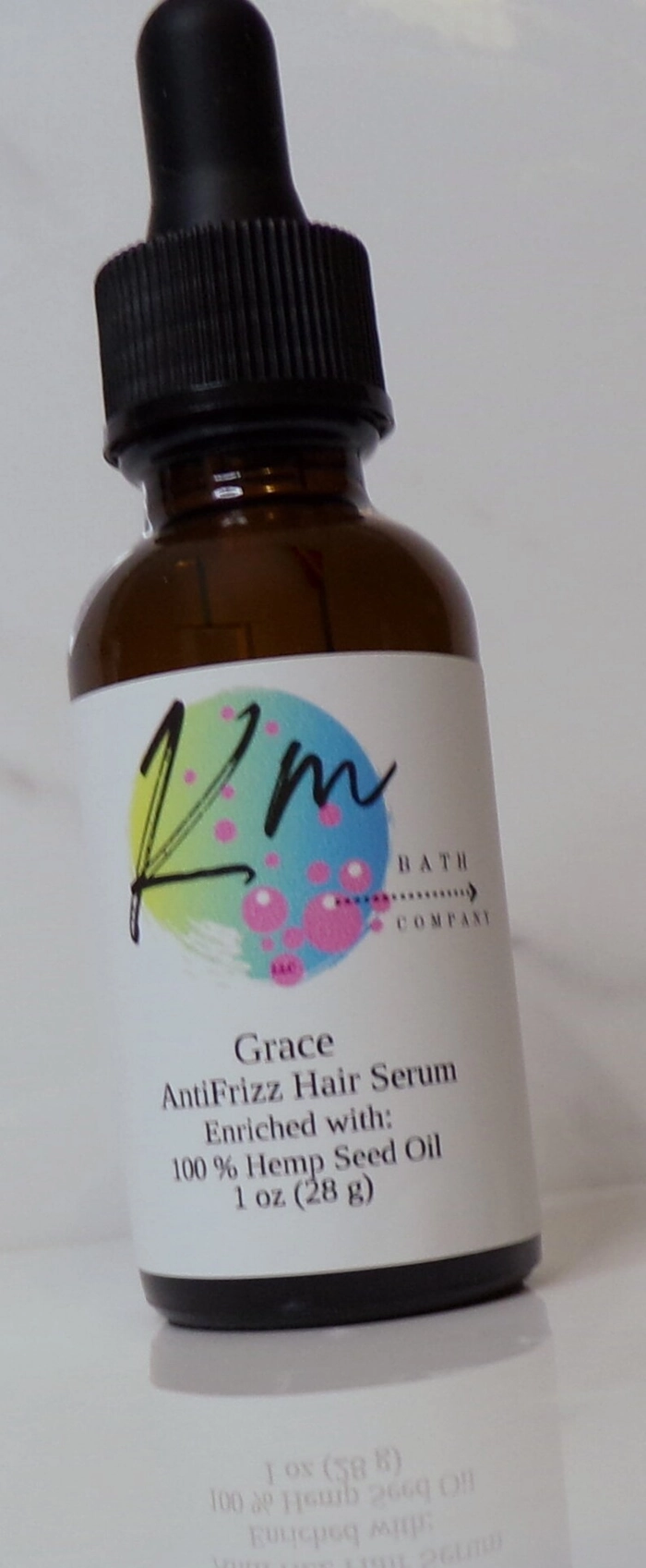 Woman applying anti frizz serum to her graduation hairstyle