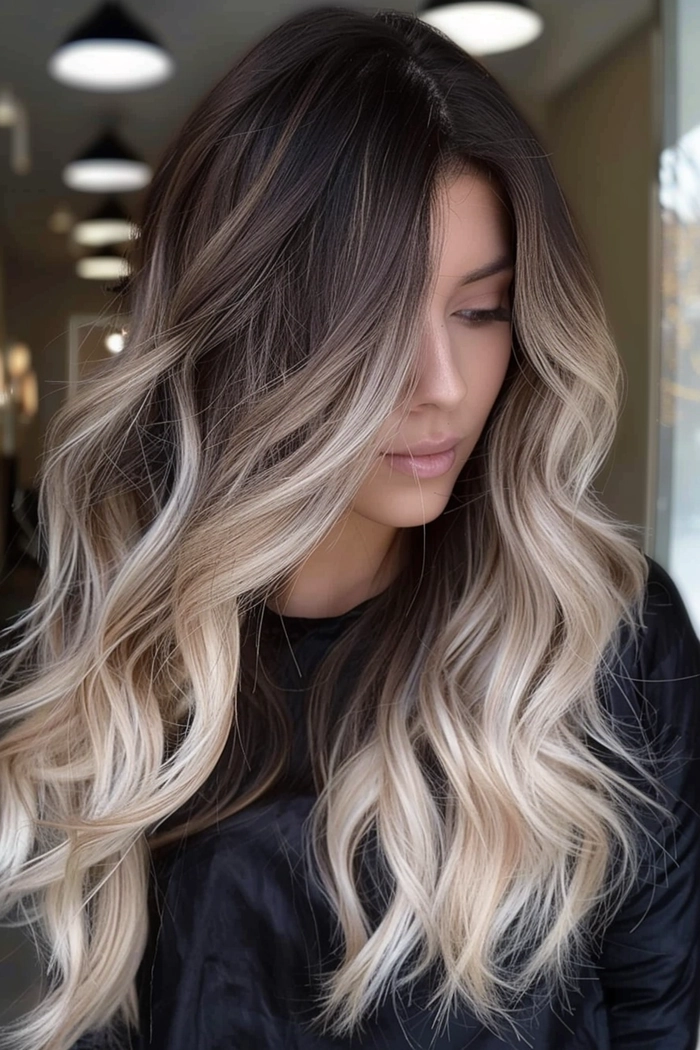 Balayage graduation hairstyle with subtle sun-kissed tones Soft balayage highlights framing a graduation cap and gown