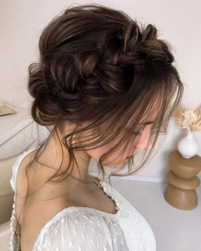Graduation hairstyle featuring loose waves, braids, and delicate flowers Boho chic graduation hair inspiration with braided crown and floral accents