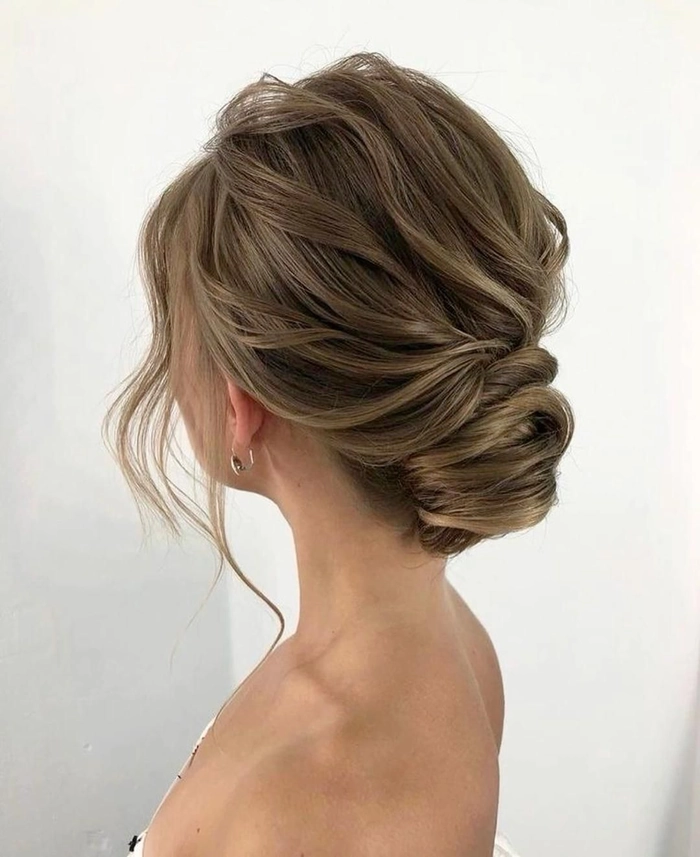 Elegant chignon bun graduation hairstyle with smooth upswept sides