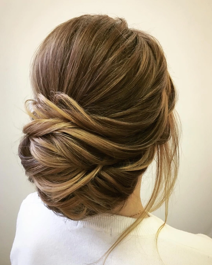 Side view of a chignon bun graduation hairstyle with cap and gown